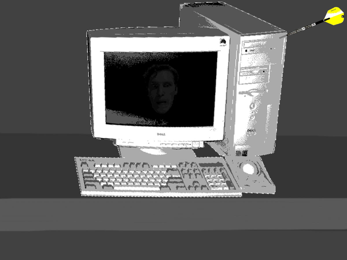 A black and white Windows 98 computer, with a dartboard dart sticking out of the tower.